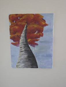 Red tree on blue grey background
